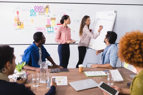 Preview: Business people discussing while working in office