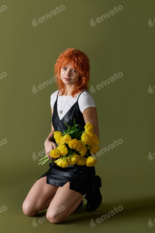 Preview: Trendy spring fashion with redhead woman in stylish leather dress and fresh yellow roses