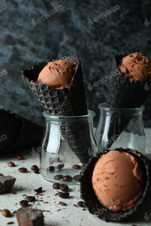 Preview: Black cones with ice cream against dark background