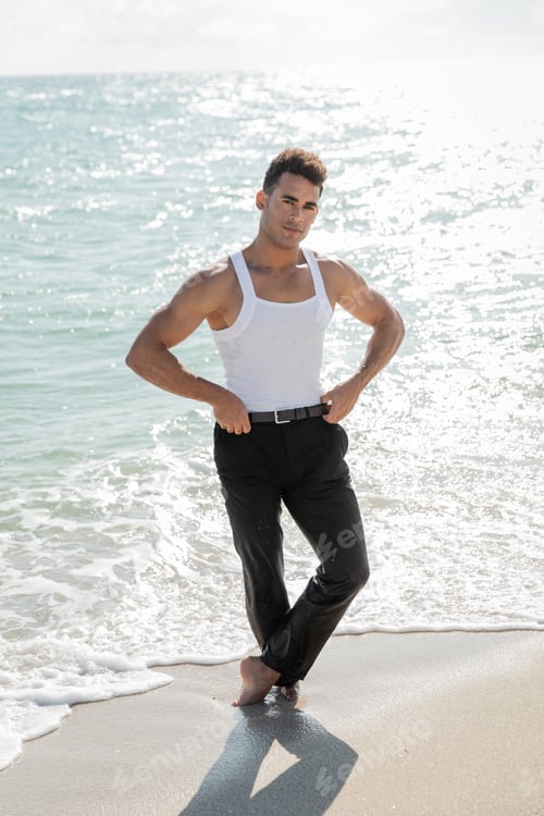 Preview: handsome and muscular Cuban man standing in ocean water in Miami South Beach, Florida