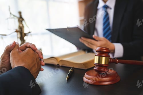 Preview: Lawyer or judge reading the law in client's trial at the lawyer's office, litigation consultation id