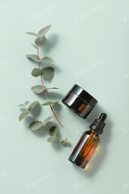 Preview: Minimal composition with cosmetic skin care products and eucalyptus leaves on pastel blue background