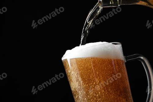 Preview: Pouring cold tasty beer from bottle into glass mug on black background, closeup. Space for text