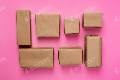 Preview: a lot of cardboard box on pink wooden background. top view