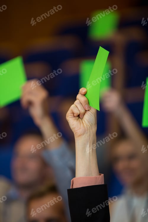 Preview: Business executives show their approval by raising hands