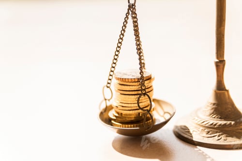 Preview: Closeup of gold coins on brass weight scale