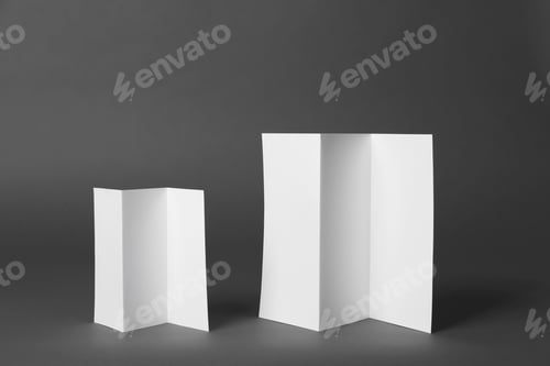 Preview: Two blank brochures on dark grey background. Mock up for design