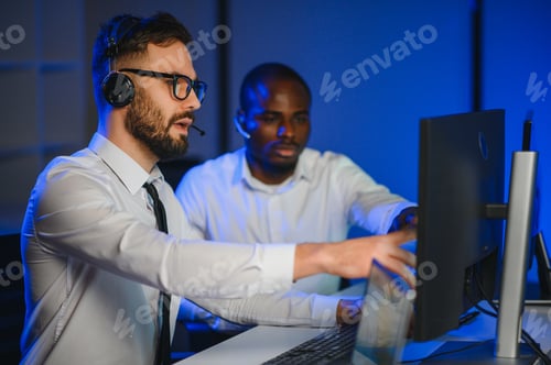 Preview: Male Data Scientist Works on Personal Computer Wearing a Headset
