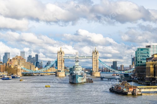 Preview: Hms belfast warship sailing under tower bridge in london, united kingdom