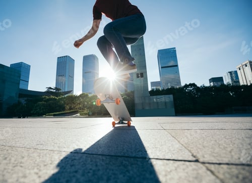 Preview: Asian woman skateboarder skateboarding in modern city