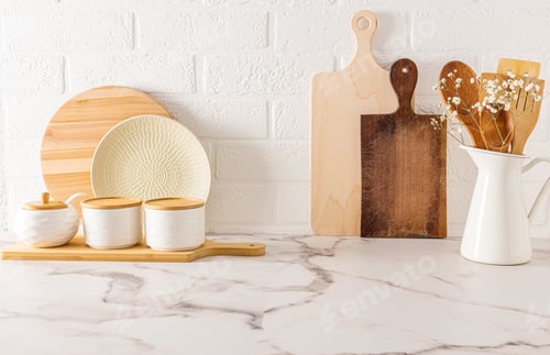 Preview: eco-friendly kitchen items on the kitchen countertop against the white brick wall.