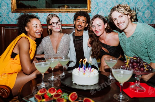 Preview: Diverse friends celebrating birthday party with cake and cocktails