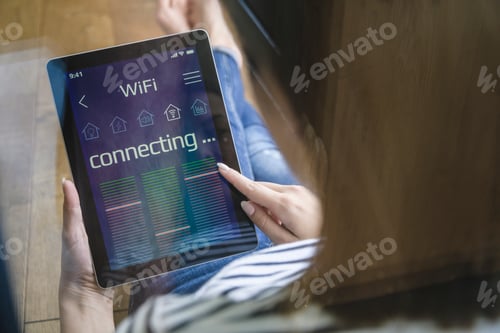 Preview: Young woman with tablet with smart home control functions