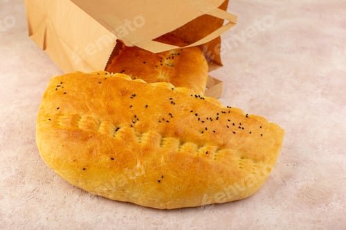 Preview: a top view baked bread hot tasty fresh inside paper packages on the pink background bakery dough