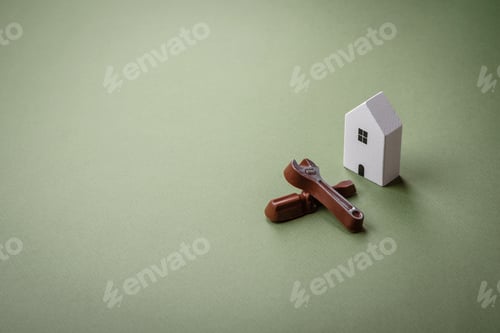 Preview: Repair or home improvement tools and a house model on a plain background