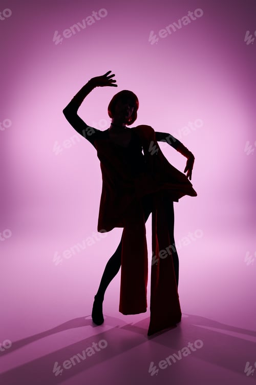 Preview: Elegant Young Drag Queen Posing Dramatically Against a Soft Purple Backdrop