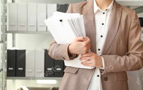 Preview: Female worker with documents in archive, closeup. Space for text