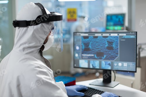 Preview: Biologist researcher man wearing coronavirus protective medical equipment