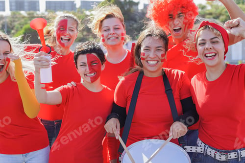 Preview: Multi generational football supporter fans watching soccer match event at stadium