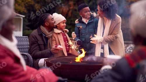Preview: Multi-Generation Family Having Fun With Firework Sparklers In Autumn Garden Together