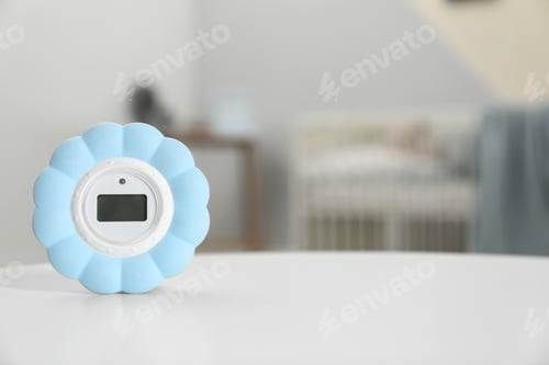 Preview: Digital temperature and humidity control in baby room interior. Space for text