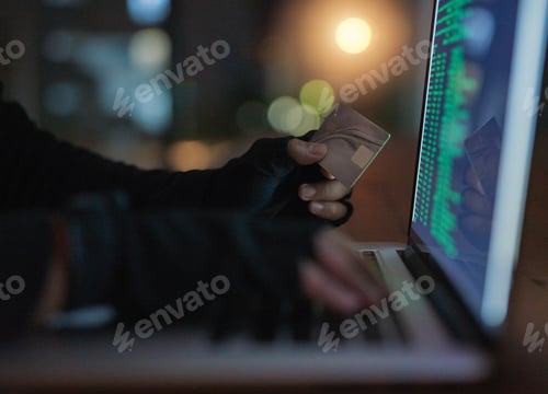 Preview: Shot of an unrecognisable hacker using a laptop to hack into a credit account