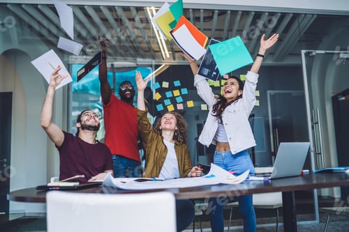 Preview: Successful partners throwing papers in air