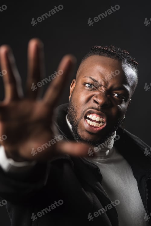 Preview: Very angry black man telling you to stop with an open hand.