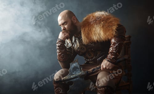 Preview: Thoughtful viking with axe sitting on chair