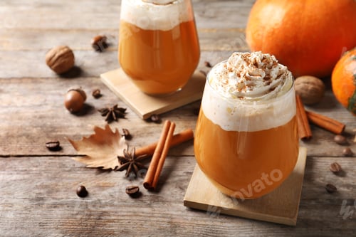 Preview: Glasses with tasty pumpkin spice latte on wooden table