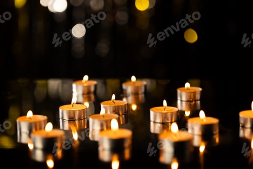 Preview: Lit tea candles with copy space on black background