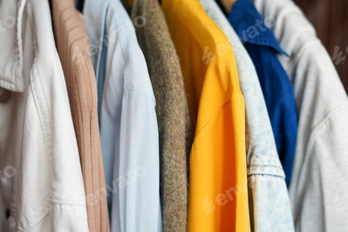 Preview: Clothing hanging on a clothing rack in a shop or home closet