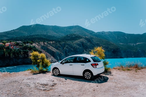 Preview: Vacation travel with car concept. Rental hired car in front of amazing bay with turquoise water