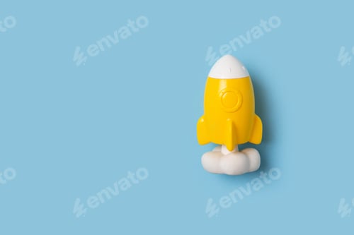 Preview: Back to school theme with yellow rocket on blue background