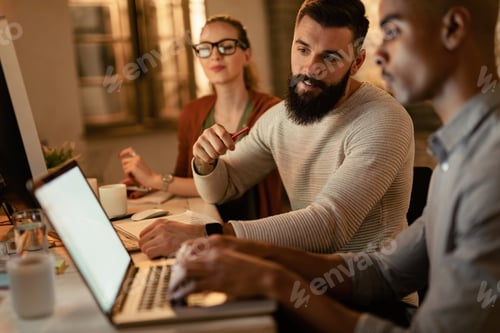 Preview: Young business people working on laptop in the office.