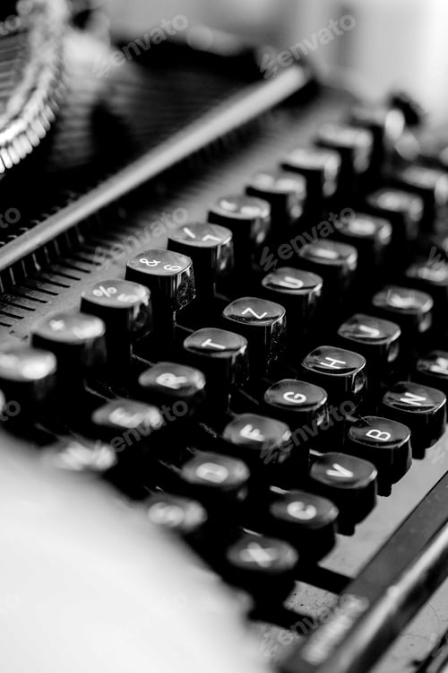Preview: Vertical shot of a black typewriter on a blurred background