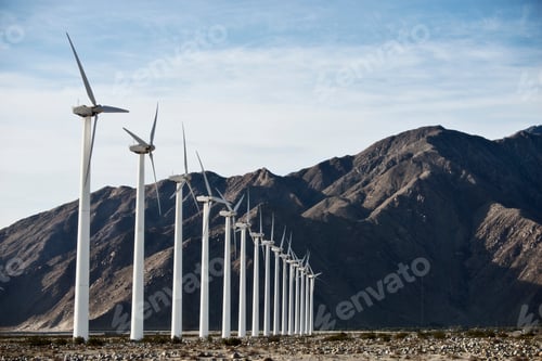 Preview: Wind power turbines against a mountain backdrop.