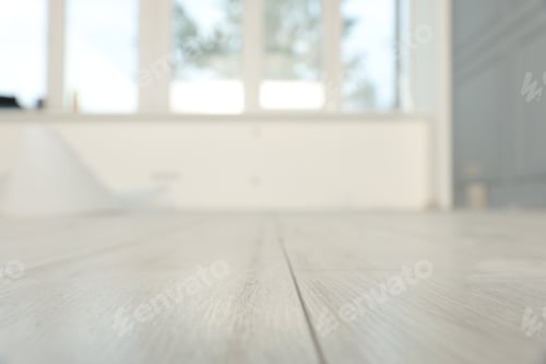 Preview: Empty room with new white laminated flooring, closeup