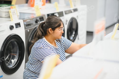 Preview: Indian woman chooses a refrigerator in a home appliance store
