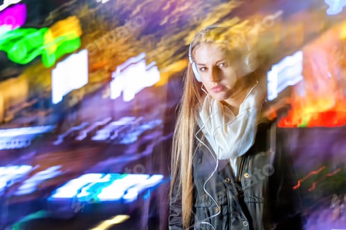 Preview: Woman in city at night among neon moving lights, fashion portrait