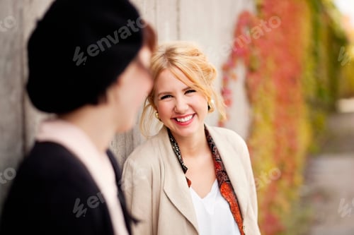 Preview: Happy female painters standing by wall
