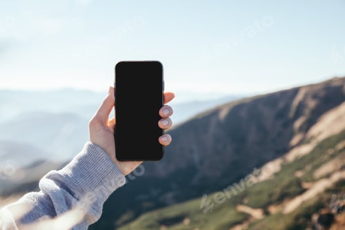 Preview: cropped shot of woman taking photo of mountain with smartphone with blank screen, Carpathians,
