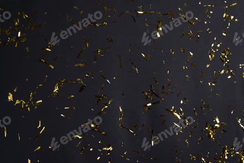 Preview: Festive party or carnival decoration golden bright confetti and coiled streamers falling against