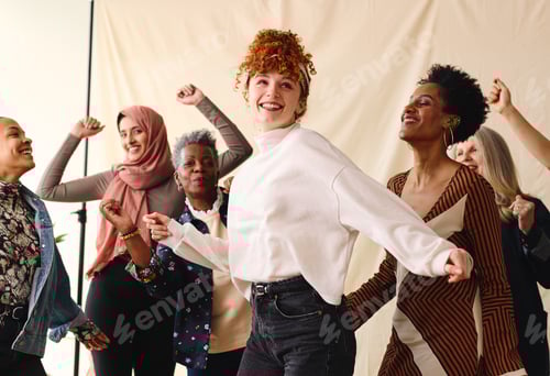 Preview: International Women's Day candid portrait of multi ethnic mixed age range women dancing