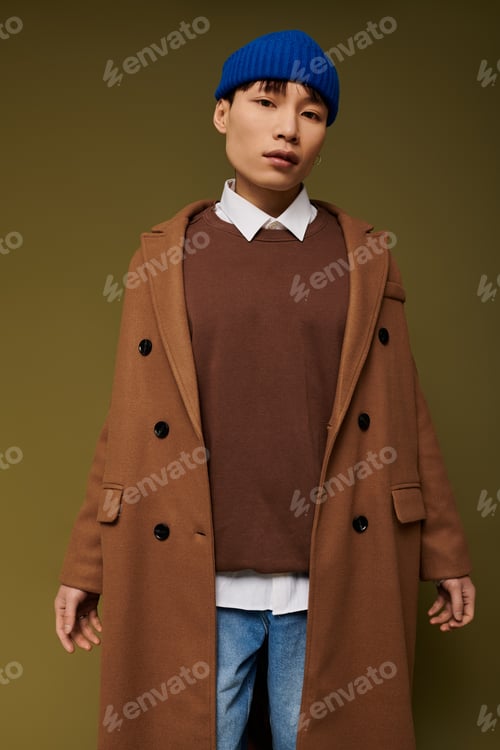 Preview: Trendy young man in brown coat and blue beanie exudes confidence in the city