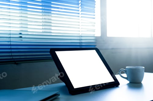 Preview: Blank screen tablet computer and a cup of coffee on the table