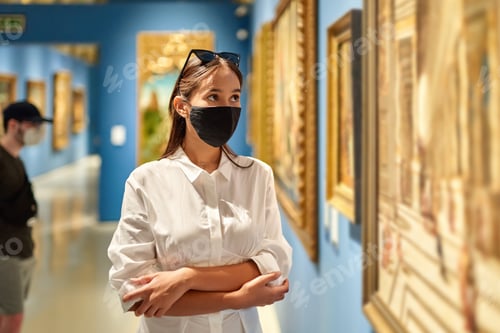 Preview: Girl Visitor Wearing An Antivirus Mask Standing Near Pictures In Museum Of Arts
