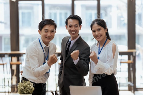 Preview: Group of asian businesspeople raises her hands up rejoices in increasing profits in business.