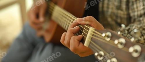 Preview: Close up shot of man playing an acoustic guitar. Relaxation, hobbies, and creativity concept
