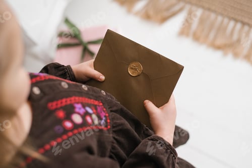 Preview: Brown envelope to Santa Claus with a wax seal in the hands of a child